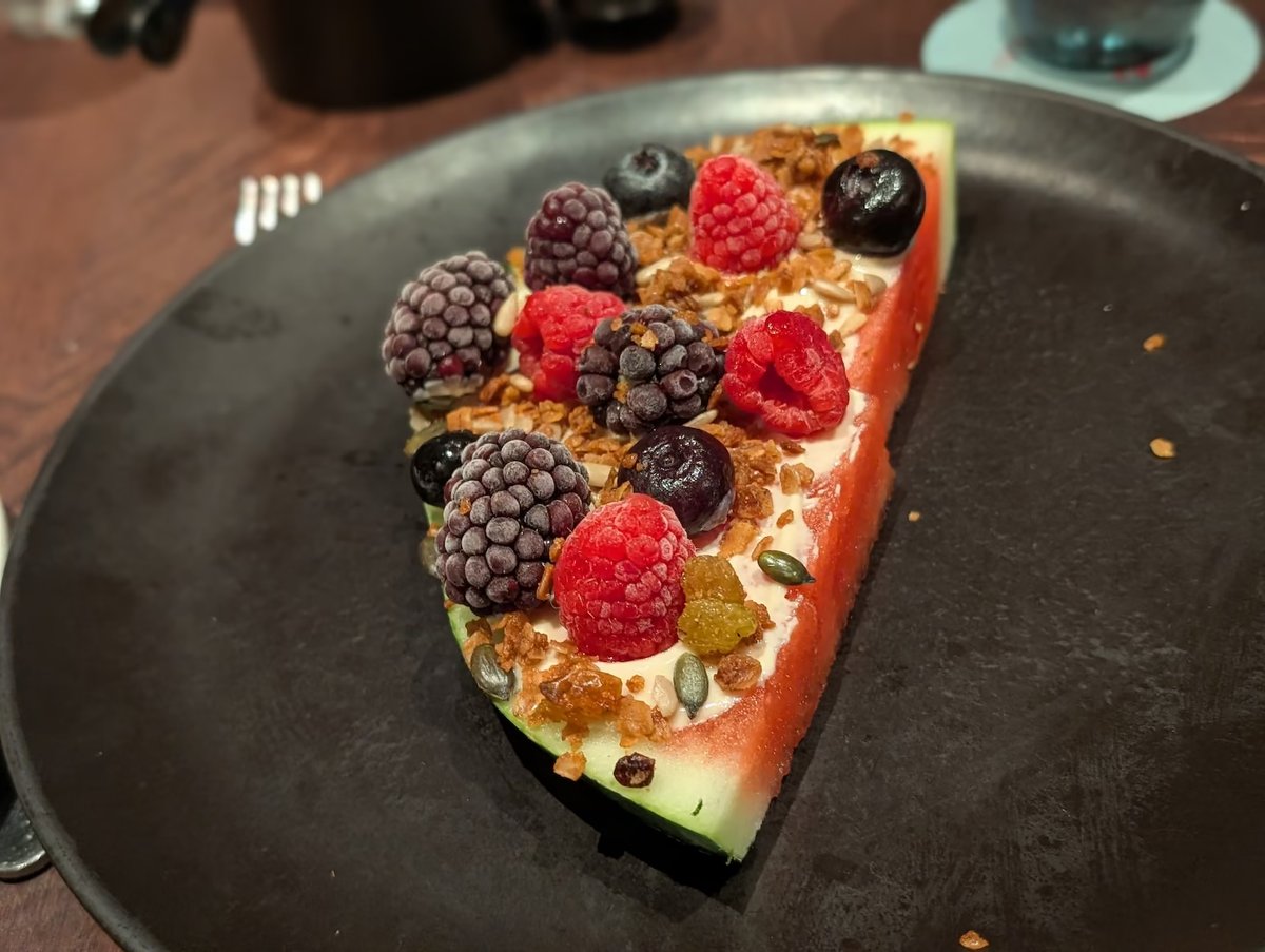 Watermelon slice topped with yogurt, granola and fresh berries at Rojo by Razzle Dazzle brunch