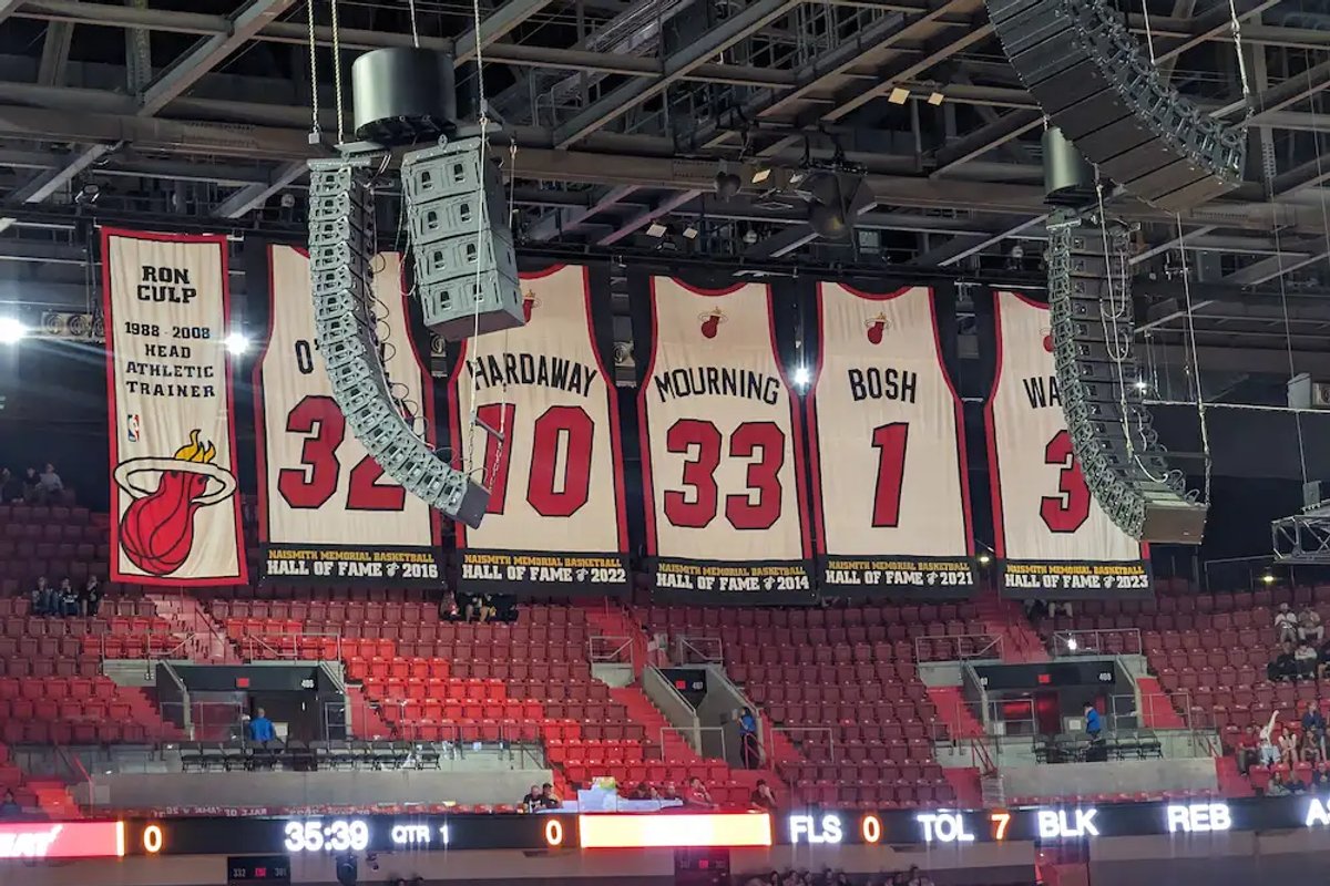 Retired jerseys hanging from the rafters at the Kaseya Center in Miami.