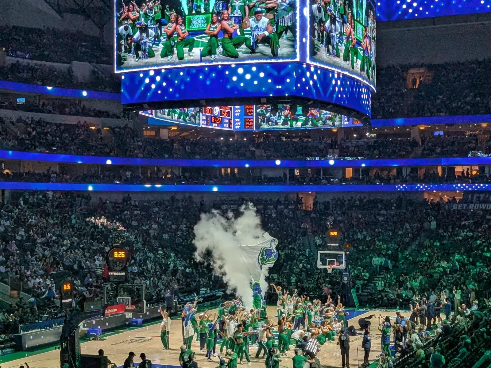 The Dallas Mavericks pregame show at American Airlines Center with dancers and a smoke machine on the court.
