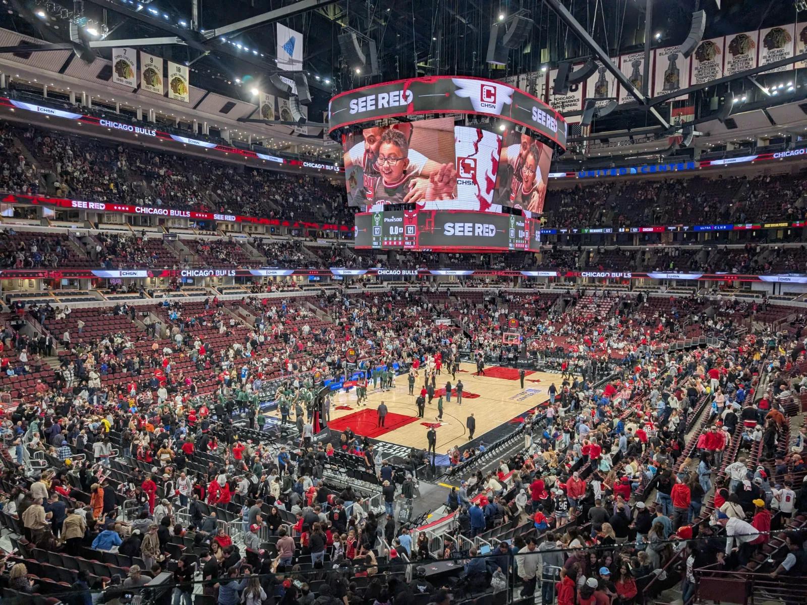 High-angle view of the court at Chicago’s United Center as fans head for the exits after a Bulls game.