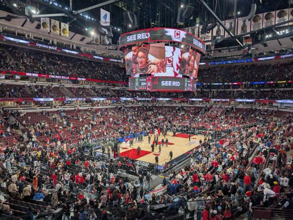 High-angle view of the court at Chicago’s United Center as fans head for the exits after a Bulls game.