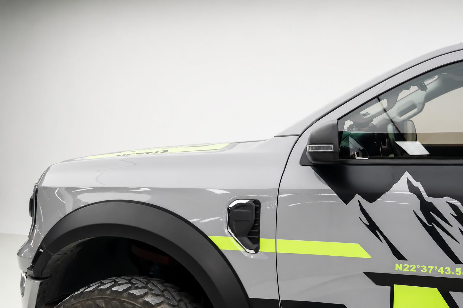 Bare pillar. Bumper lights sit in the dust the front tyres throw, so the beam lights the haze.