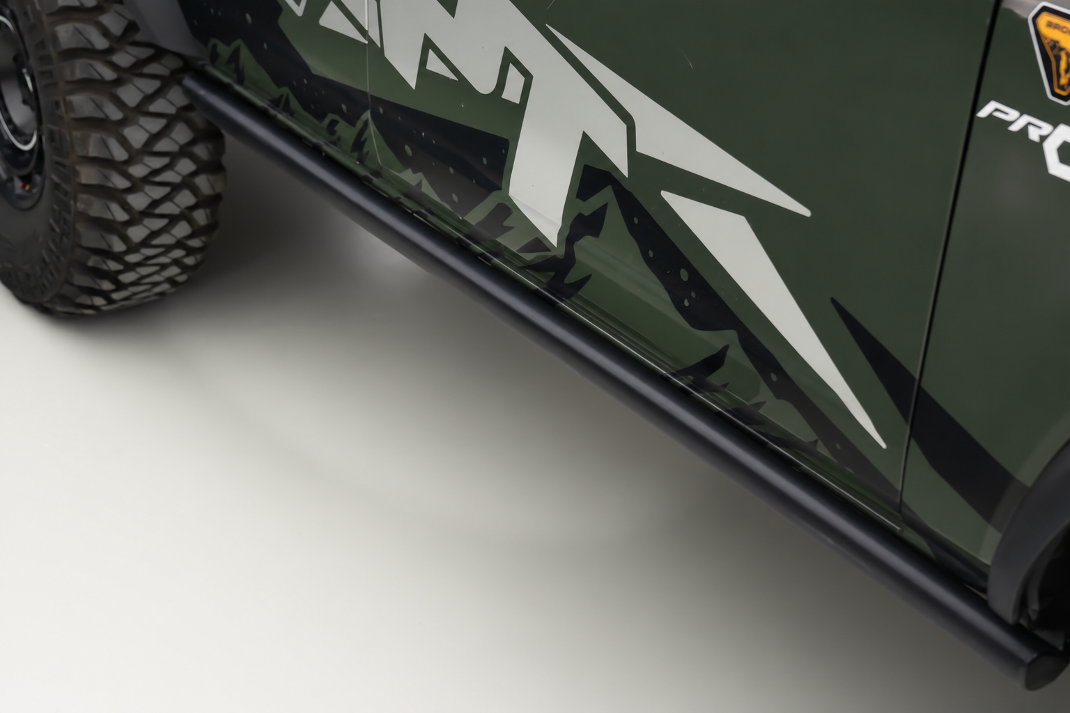 The factory rock rail, bare. Nothing on it you would want to put a boot on.