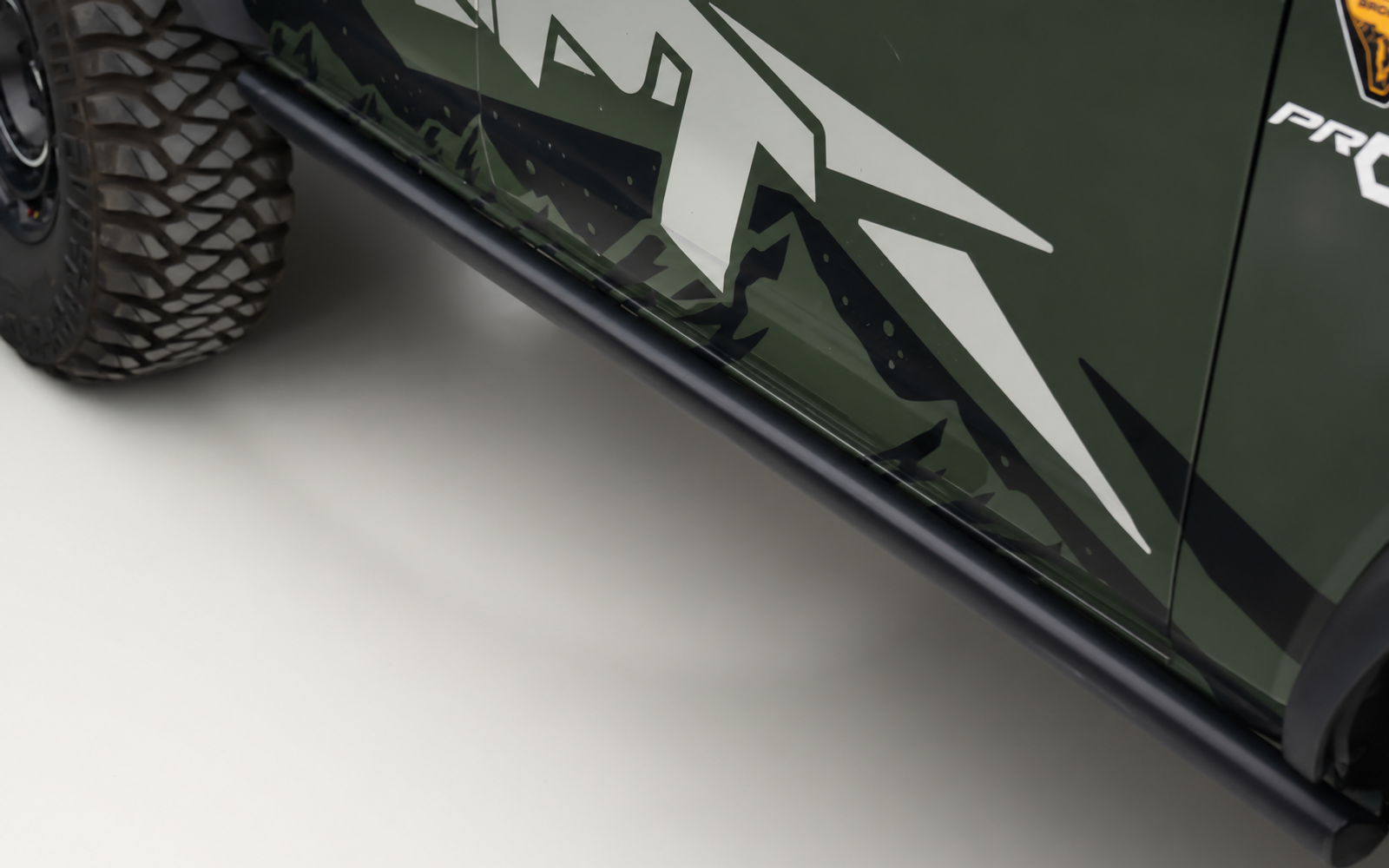 The factory rock rail, bare. Nothing on it you would want to put a boot on.