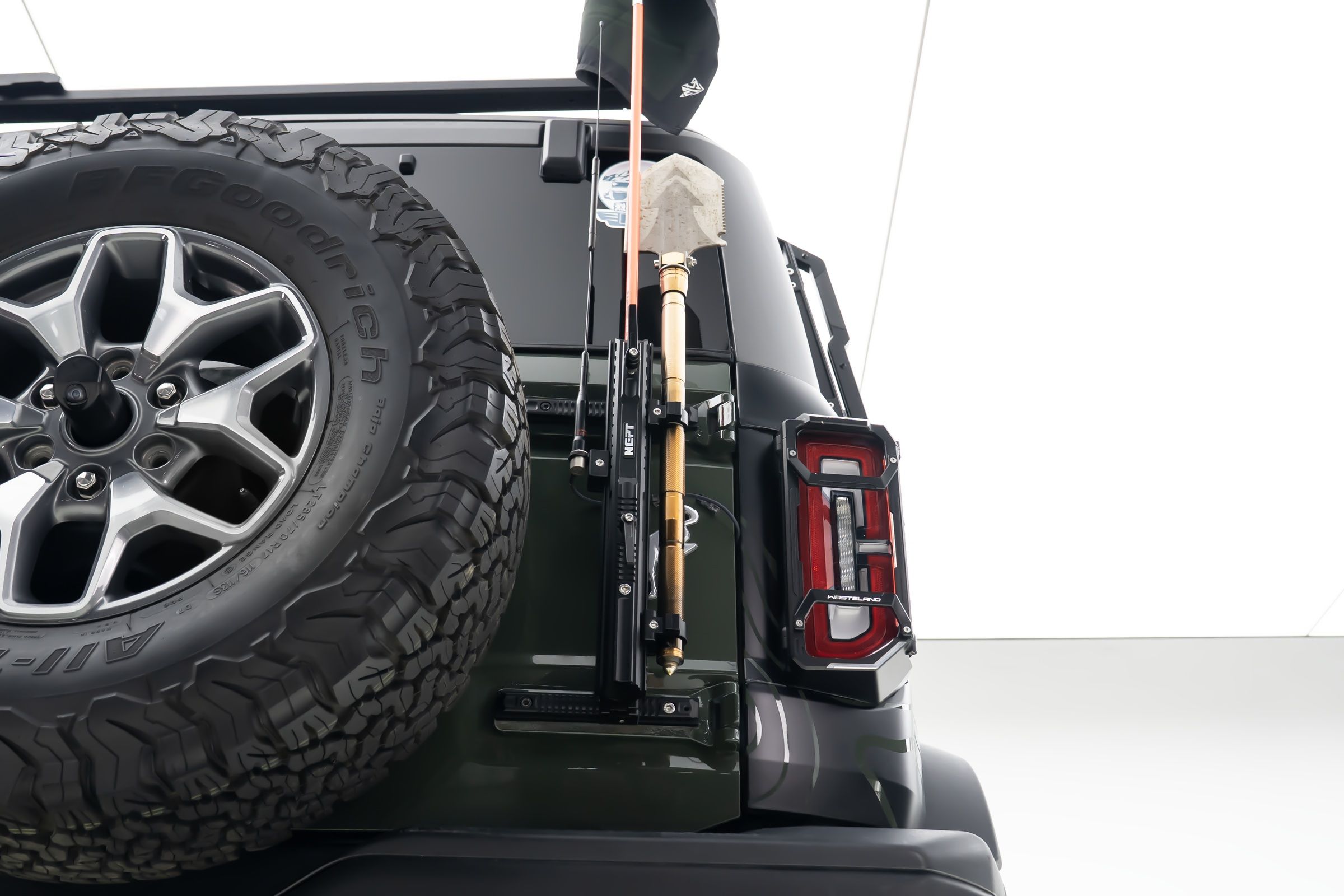 One mount holds all three, on points the tailgate already has.