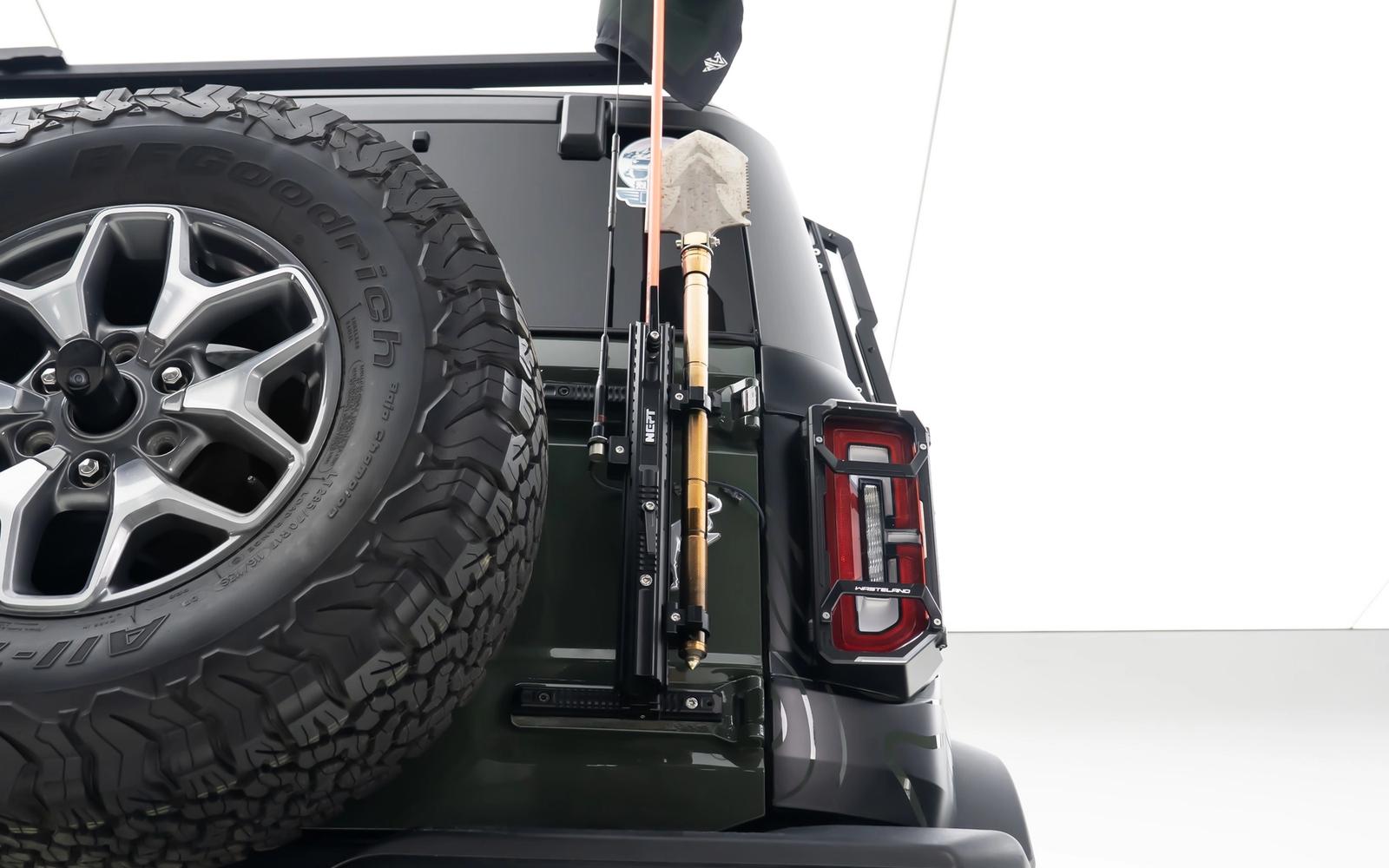 One mount holds all three, on points the tailgate already has.