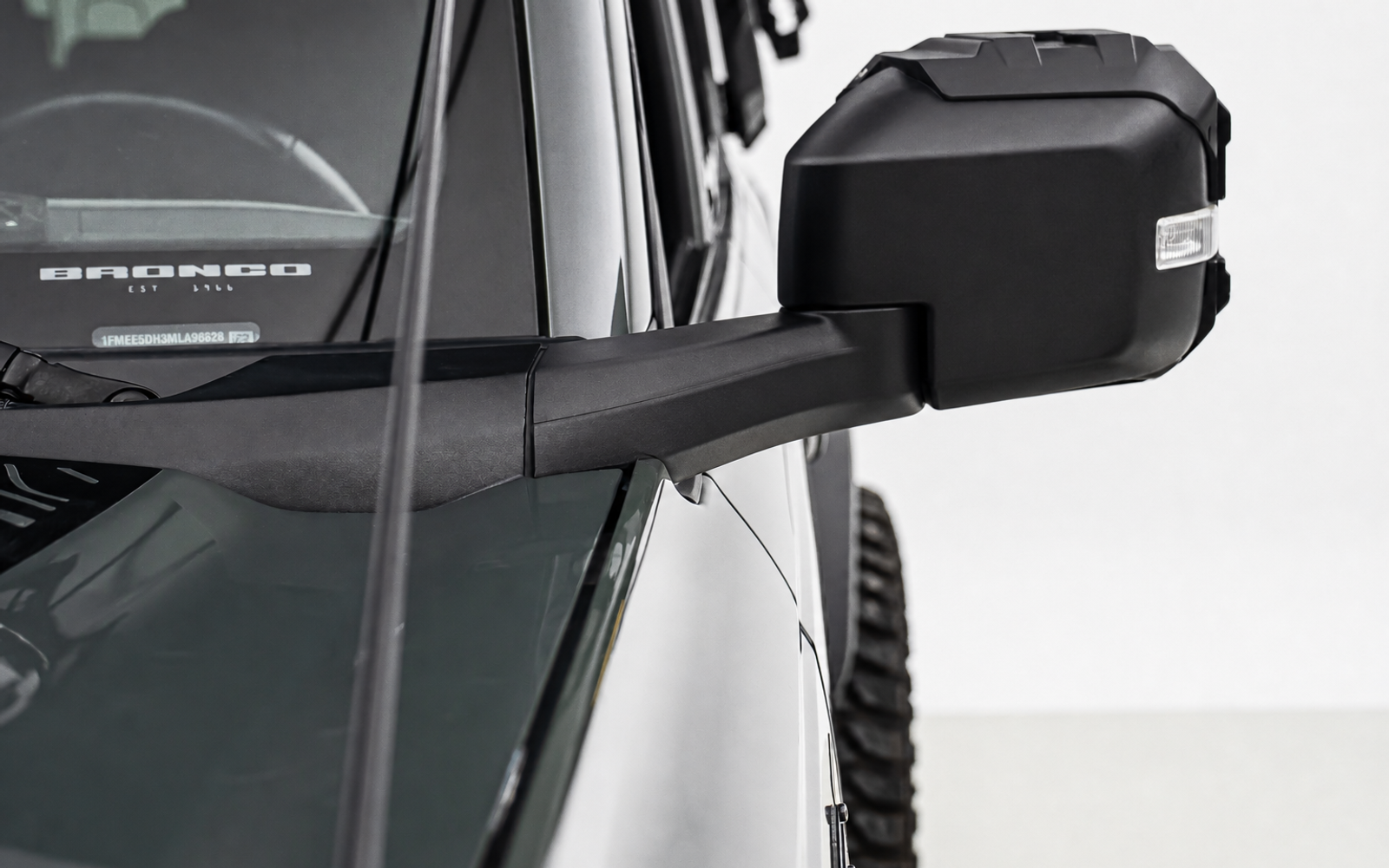 Nothing beside the mirror. Lights end up on the bumper, low, down in the dust and spray.