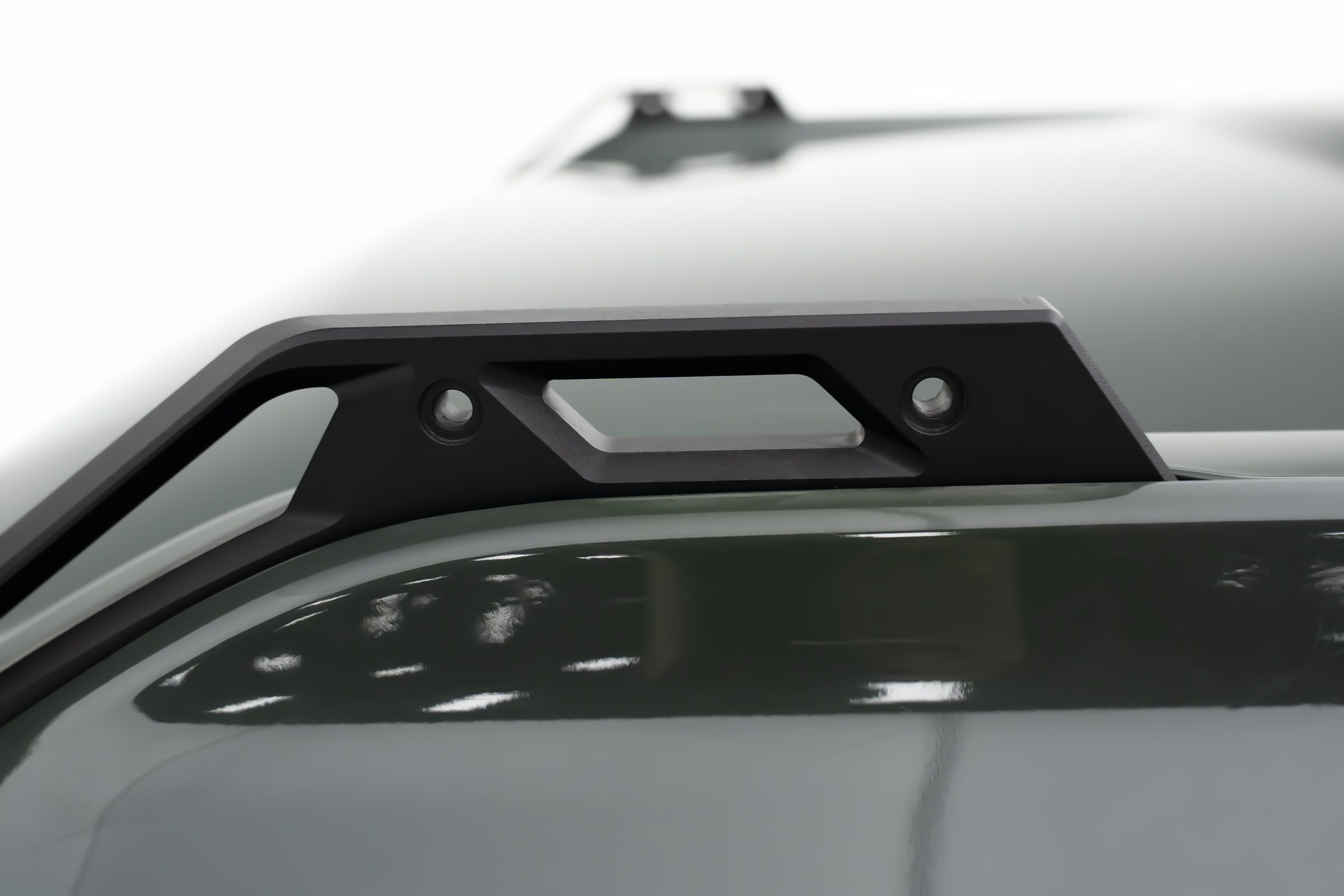 A handle on each corner. Tighten the lines without taking anything off the truck.