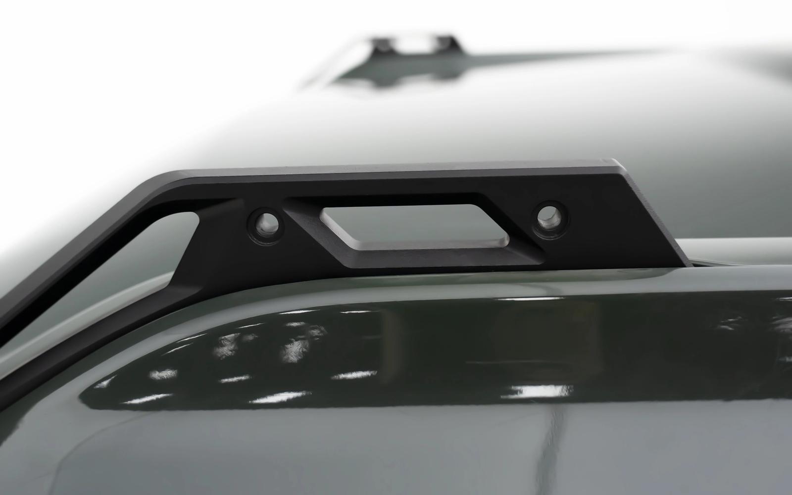 A handle on each corner. Tighten the lines without taking anything off the truck.
