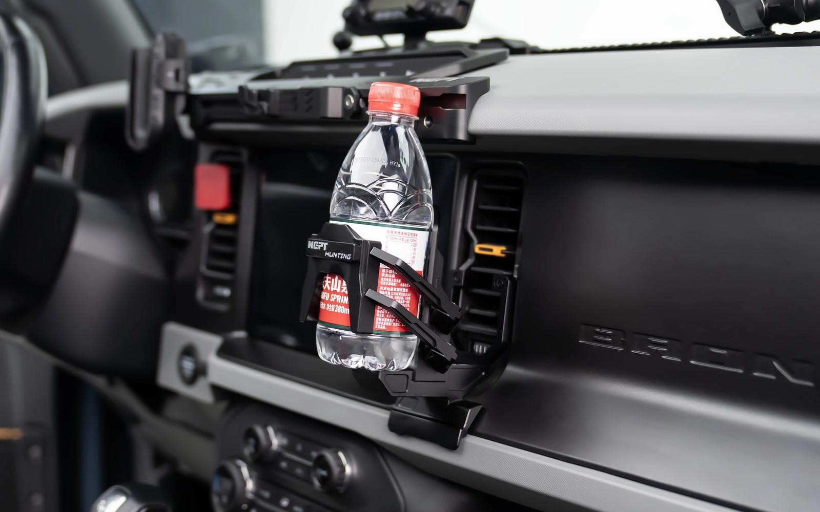 A holder up beside the screen. It grips whatever you put in it, not one size.