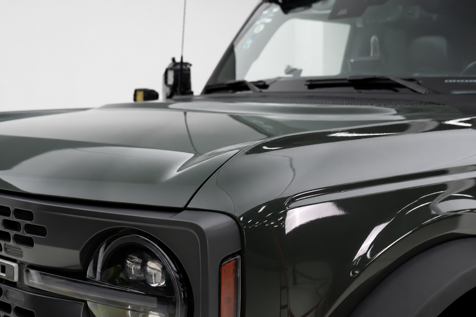 Nothing to grab at the front. On a lifted truck you end up leaning on the hood panel.