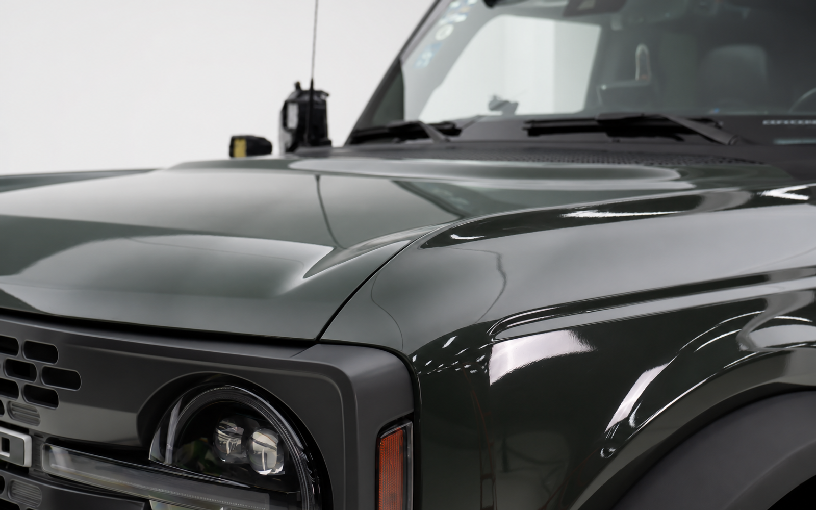 Nothing to grab at the front. On a lifted truck you end up leaning on the hood panel.