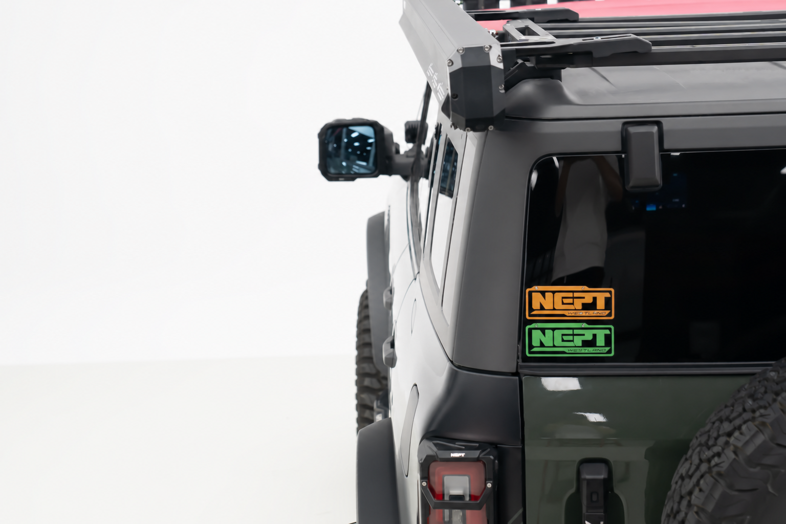 Rear side window, unused. At camp the tailgate is your only flat surface, and it is also the way into your gear.