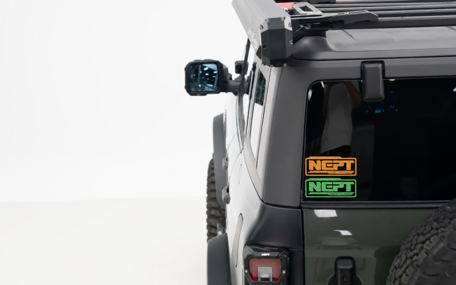 Rear side window, unused. At camp the tailgate is your only flat surface, and it is also the way into your gear.
