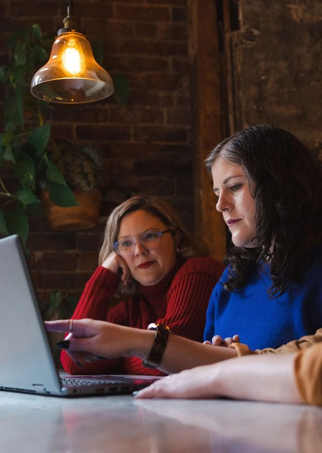Lesley Alex and Haley collaborating in front of a laptop
