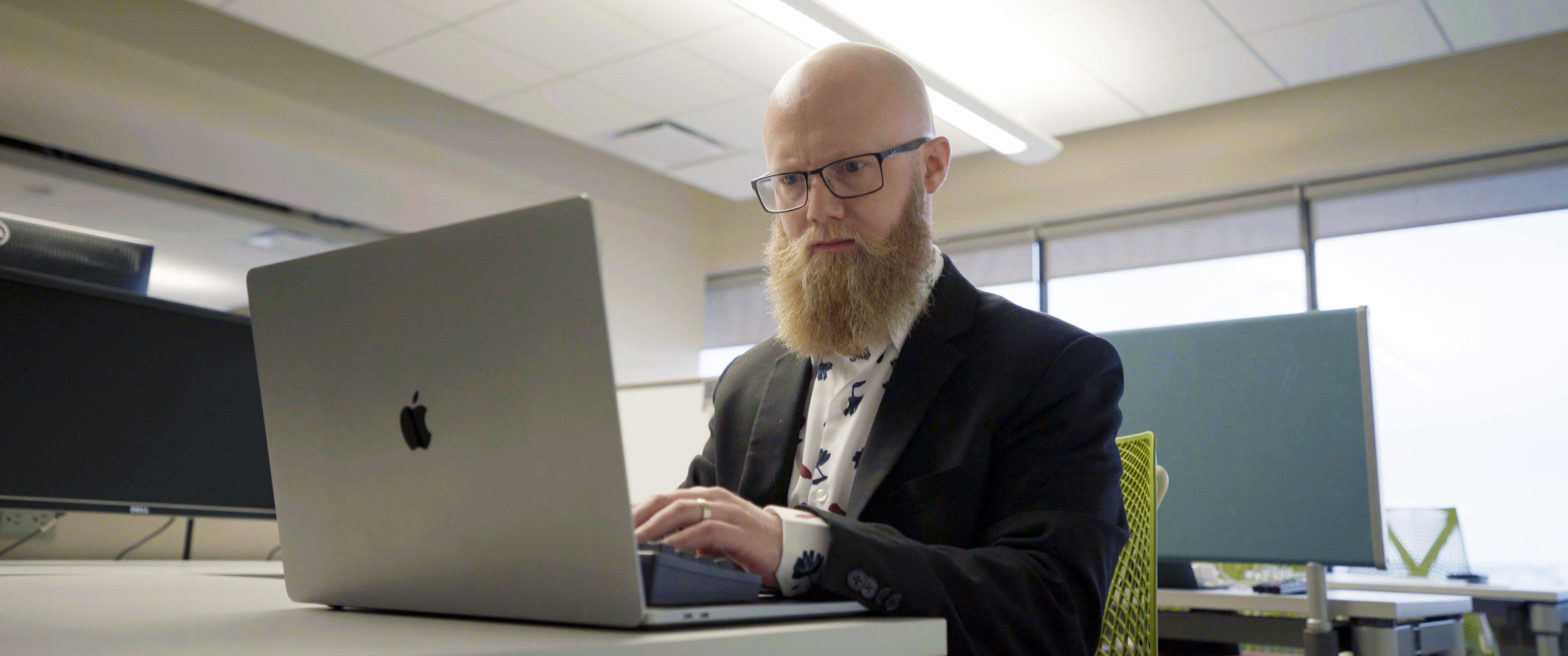 Rob programming at his computer