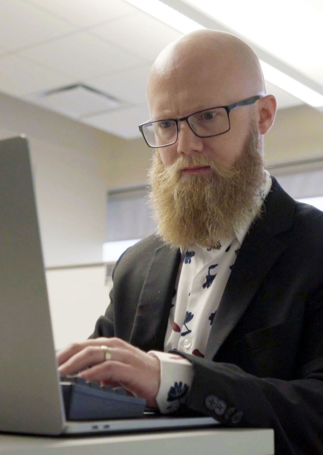 Rob programming at his computer