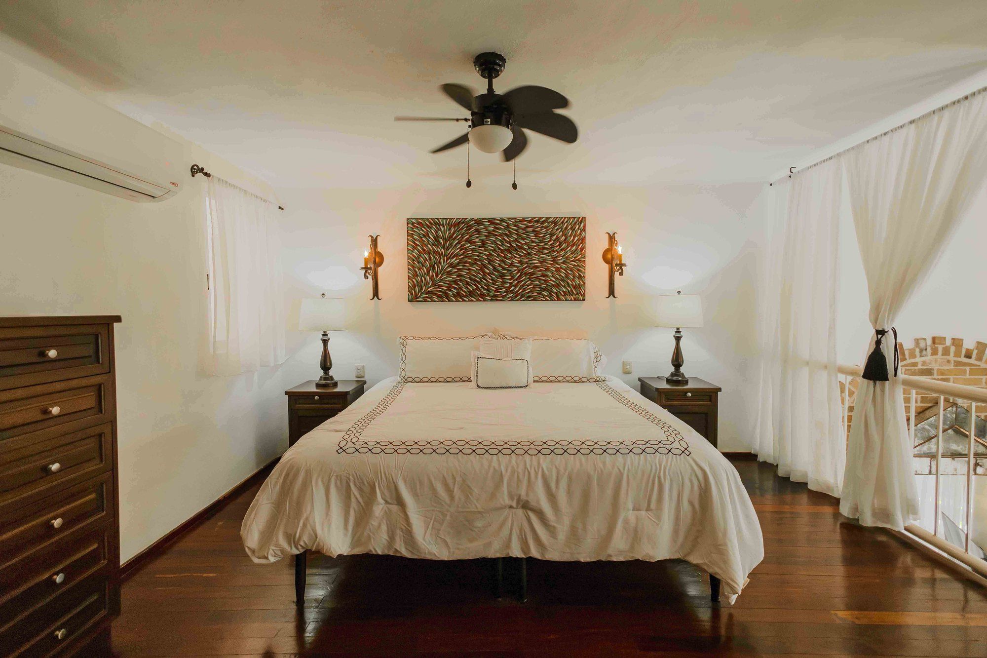 Loft bedroom with a bed and wood flooring