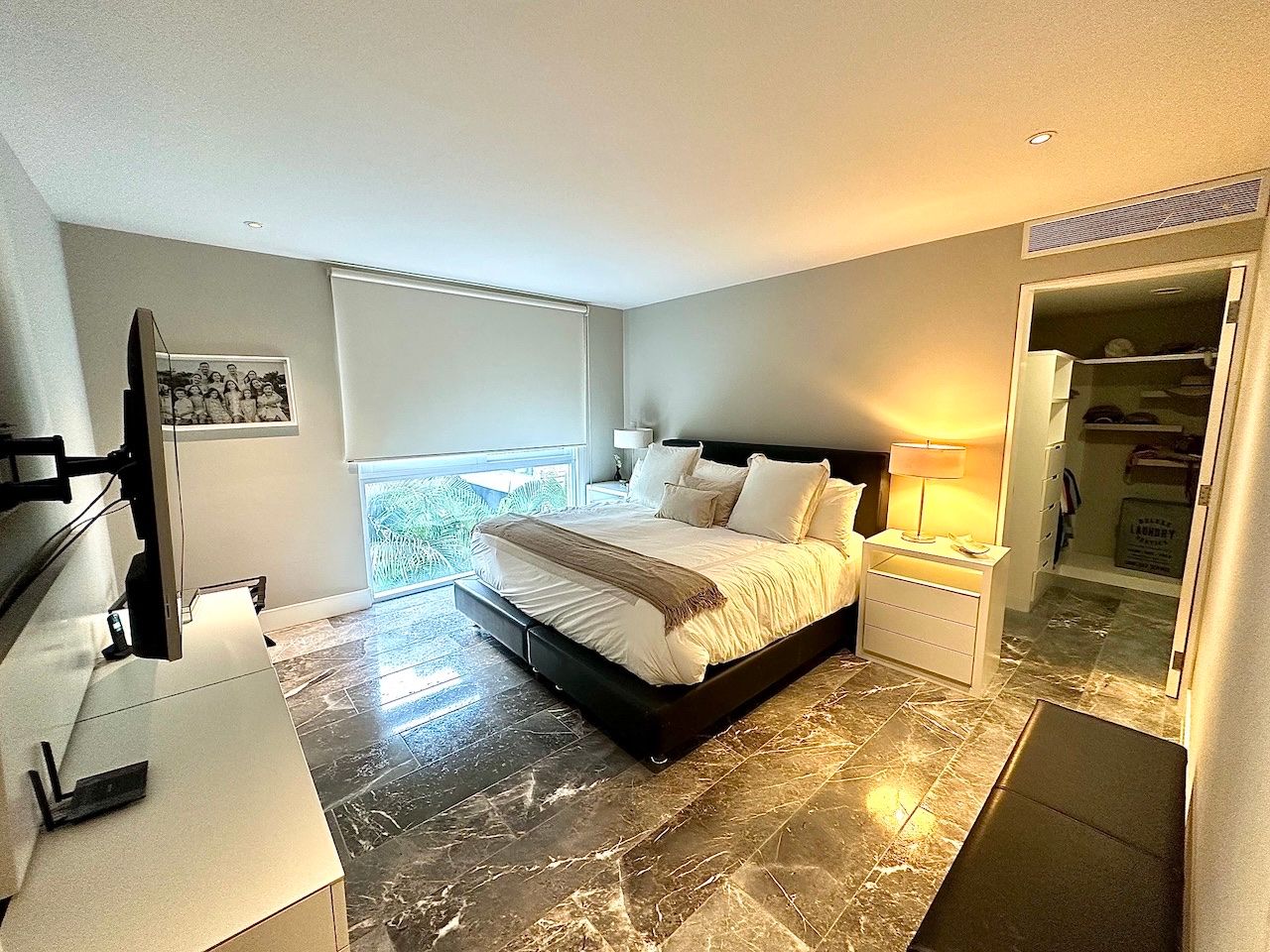 Primary bedroom with a walk-in closet beyond at Vaivén del Mar