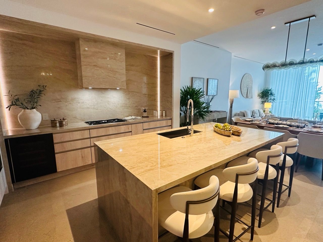 One-bedroom showroom kitchen with a travertine waterfall island at One Laguna