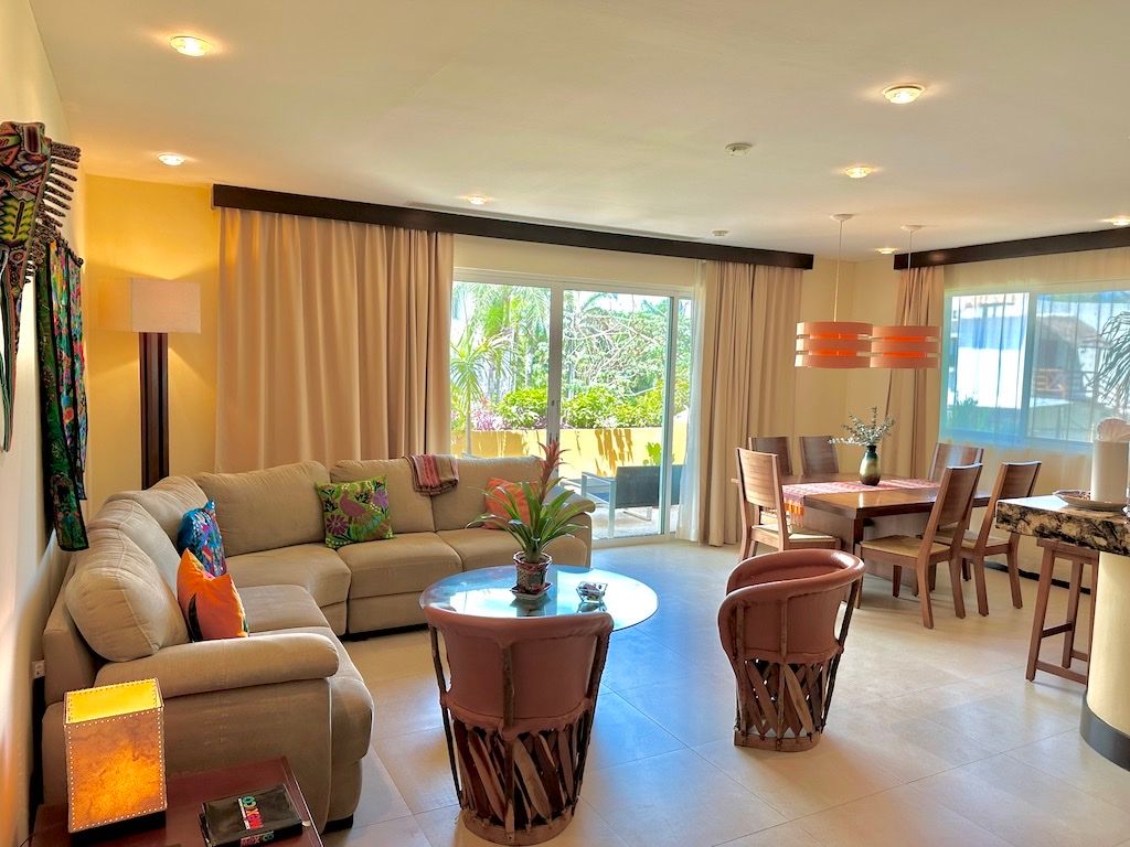 Living and dining area with colonial-style furniture opening onto the terrace at Pueblito Escondido