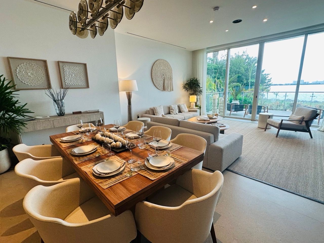One-bedroom showroom living and dining area with a direct waterfront outlook at One Laguna