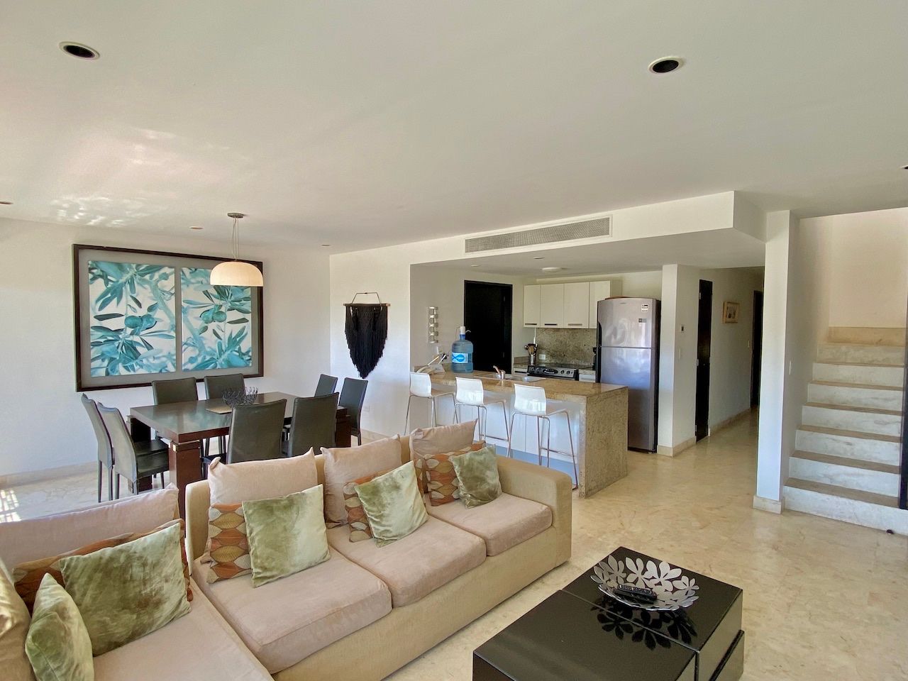 Living area, kitchen and staircase to the residence's upper level at The Elements PH21