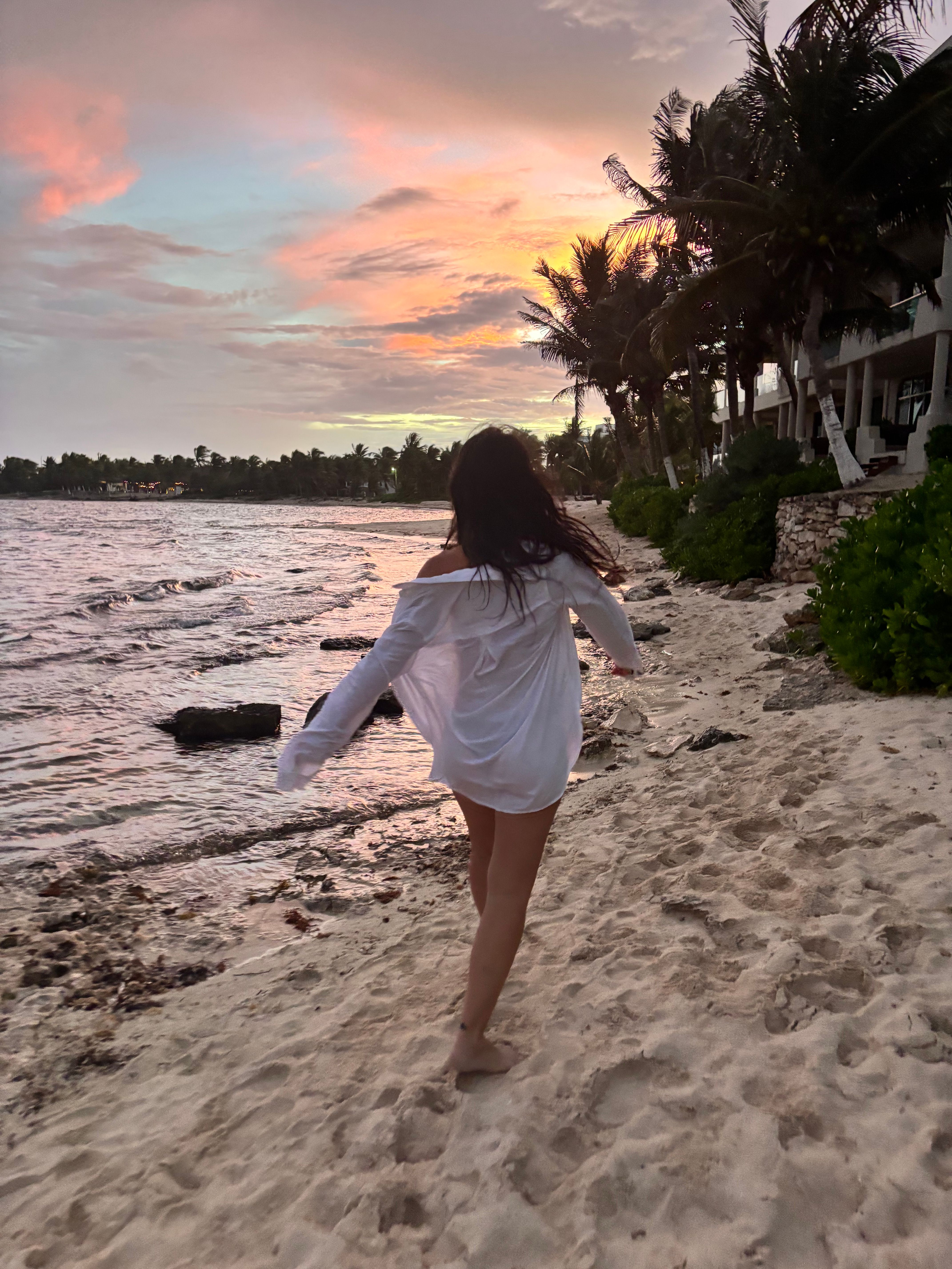 Stephanie walking along the beach at sunset.