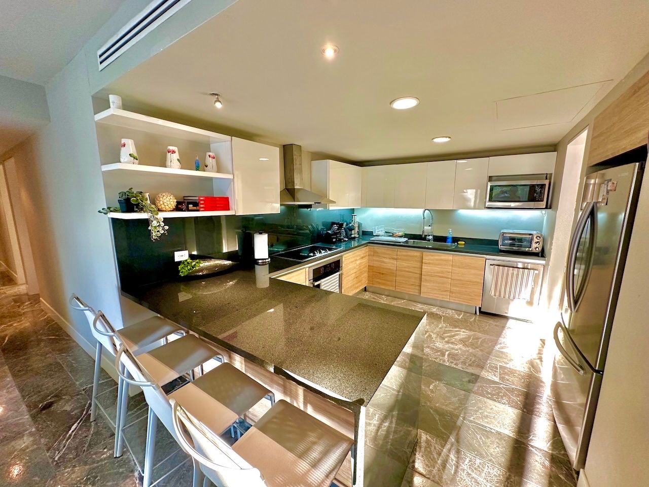 Open kitchen with breakfast bar seating at Vaivén del Mar