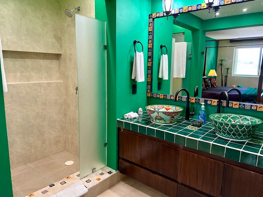 Primary en-suite bathroom with hand-painted Talavera vessel sinks at Pueblito Escondido