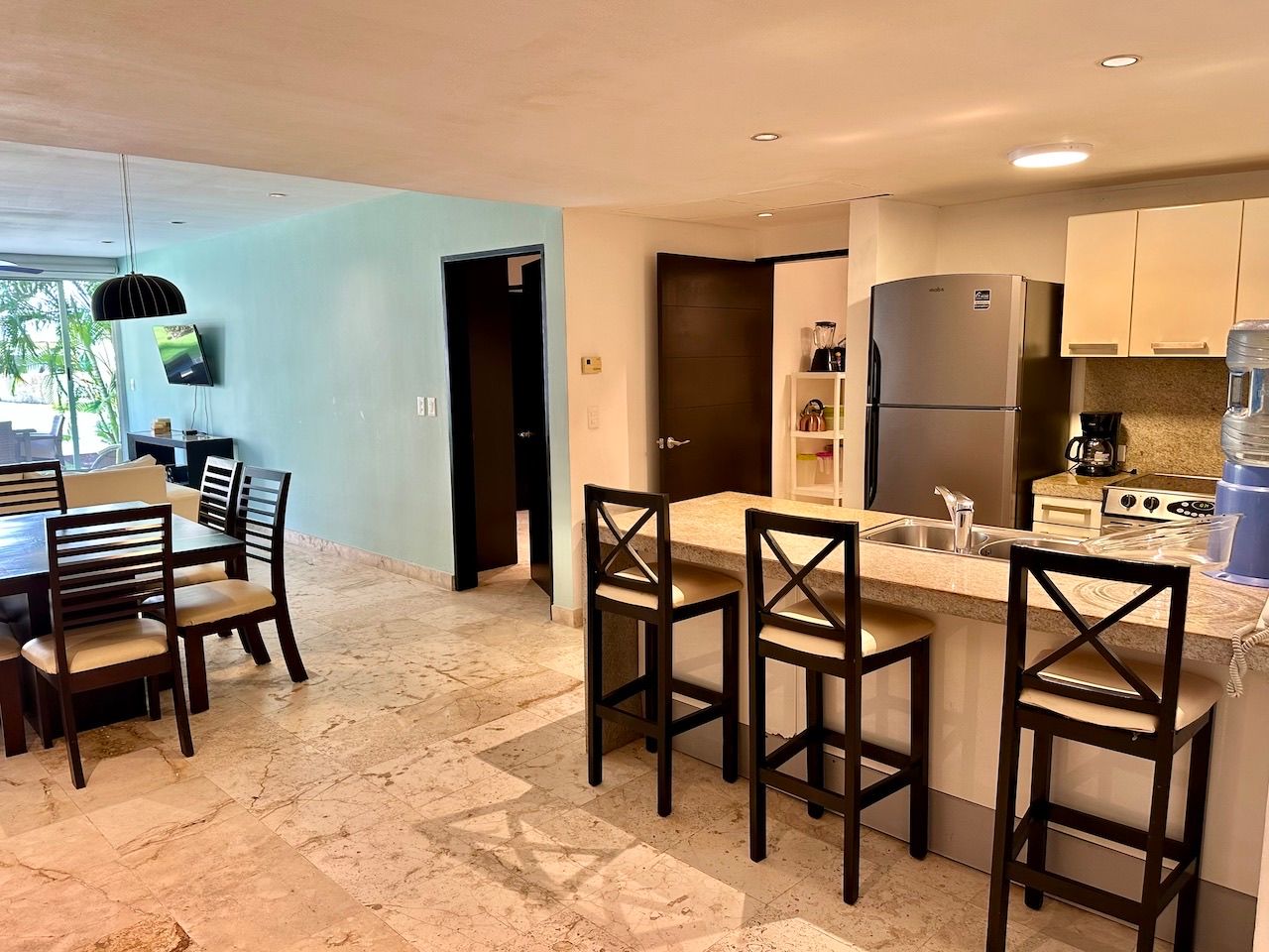 Ground-floor living room opening to the lawn and pool at The Elements GH3