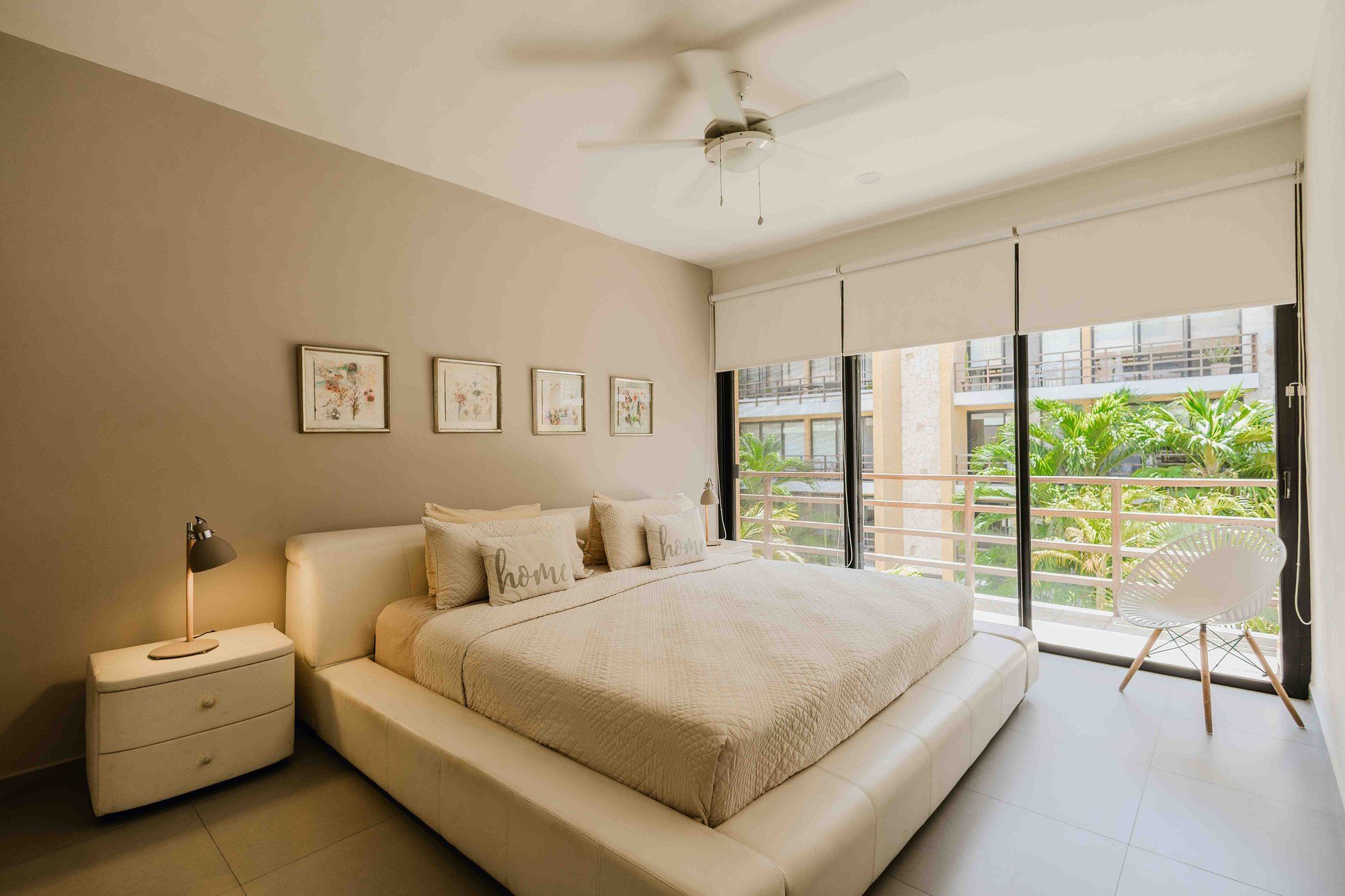 Bedroom with a platform bed and sliding glass doors to the balcony at Lunada 314