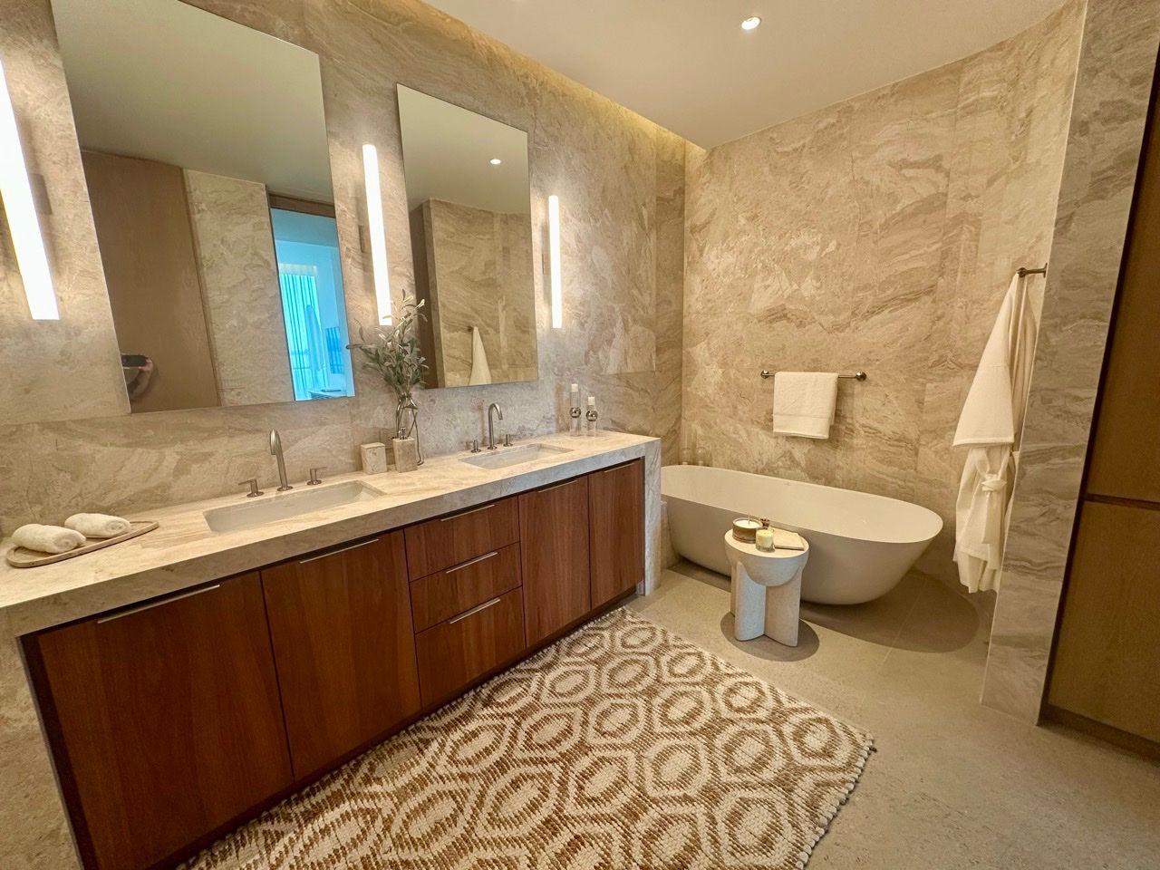 One-bedroom showroom marble bathroom with a freestanding tub and double vanity at One Laguna