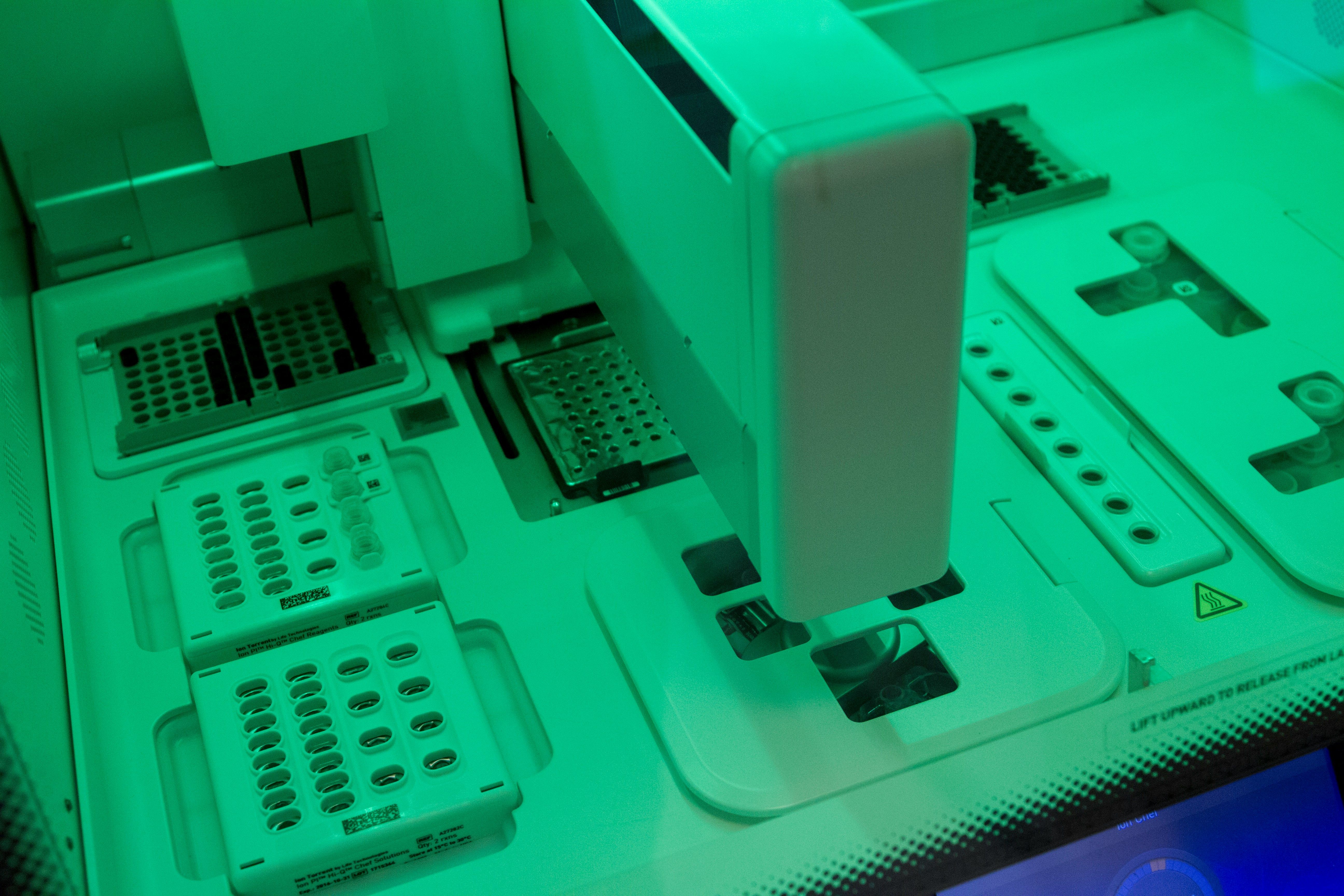 A researcher interacting with a next generation sequencer