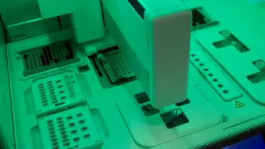 A researcher interacting with a next generation sequencer