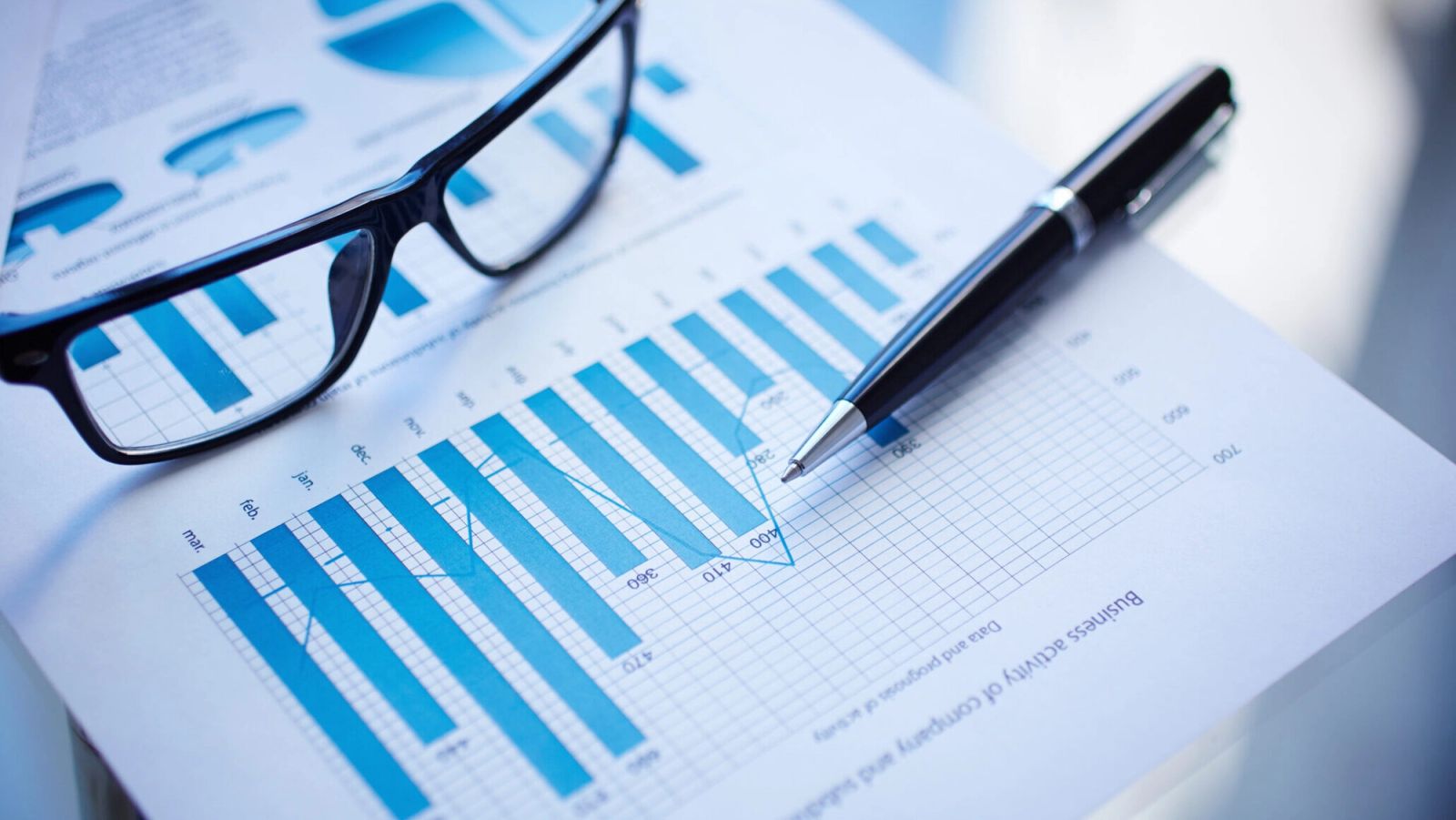 Image of eyeglasses, pen, and performance document
