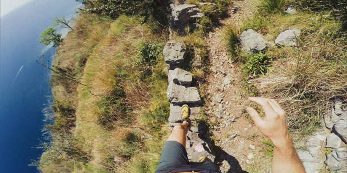 A POV of a man jogging in a forest terrain