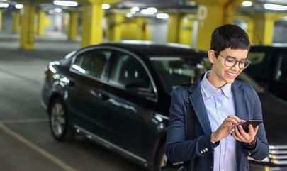 woman smiling at her phone inside parking garage