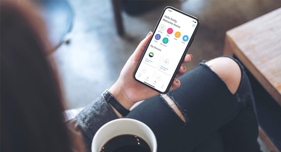 Woman holding phone with SmartRent mobile app visible