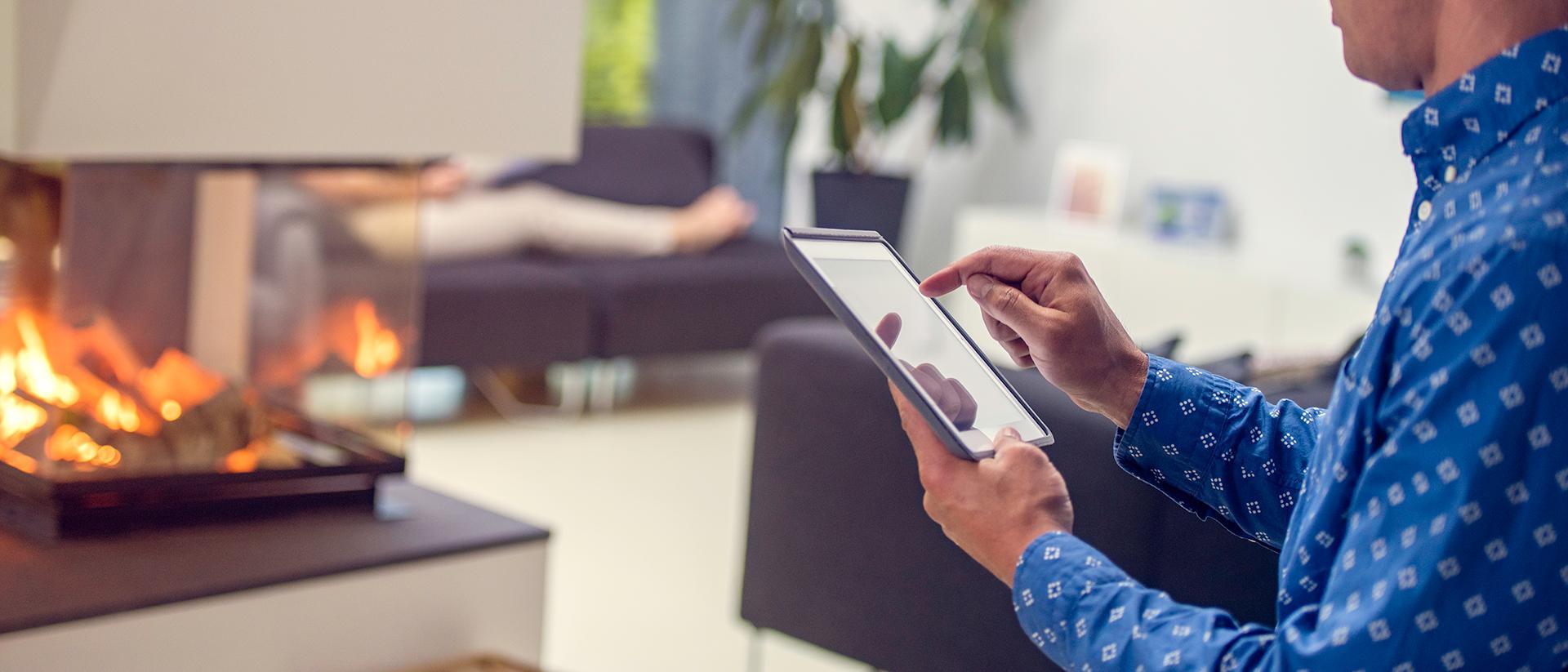 man using iPad in apartment