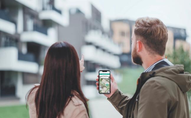 Two prospective residents use a self-guided touring app while touring an apartment community.