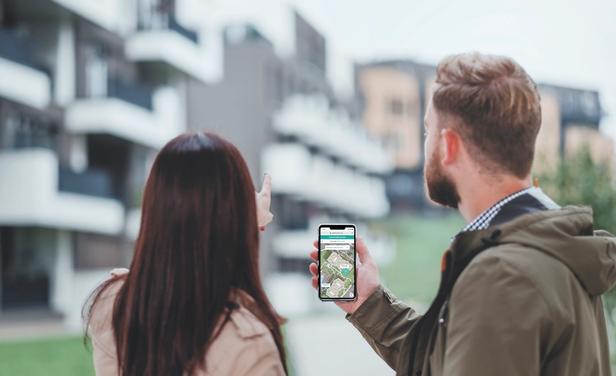 Two prospective residents use a self-guided touring app while touring an apartment community.