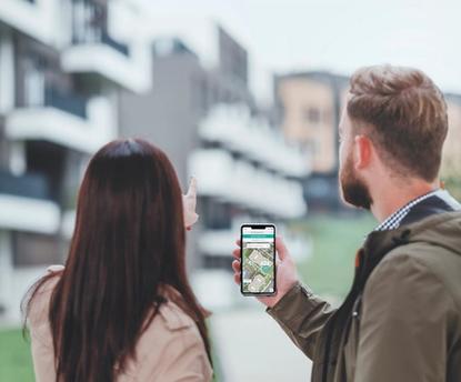 Two prospective residents use a self-guided touring app while touring an apartment community.