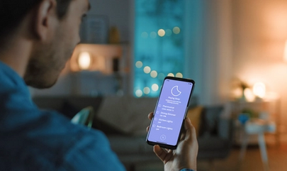 Image of person controlling smart lights on phone