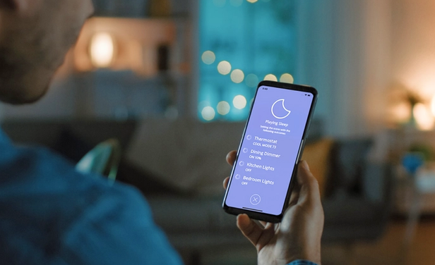 Image of person controlling smart lights on phone