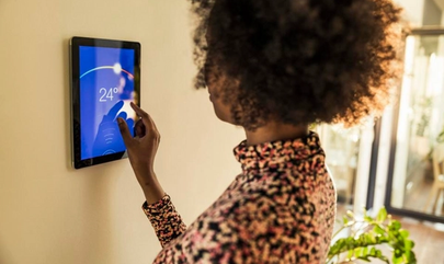 Image of woman using smart home device