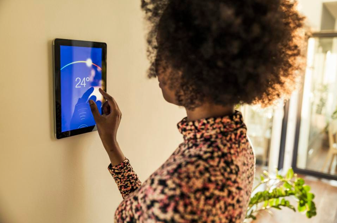 Image of woman using smart home device