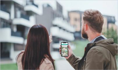 couple touring apartment community with SmartRent self-guided tours app on phone