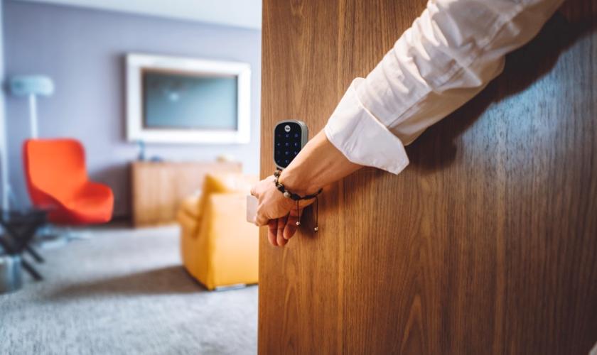 person entering a home with smart lock on the door