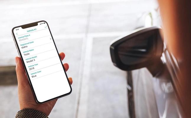 SmartRent user holds a smartphone with parking information displayed on the screen.
